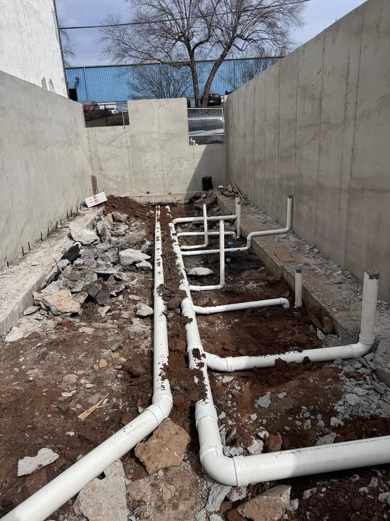 White PVC drain lines laid in a new Philadelphia foundation